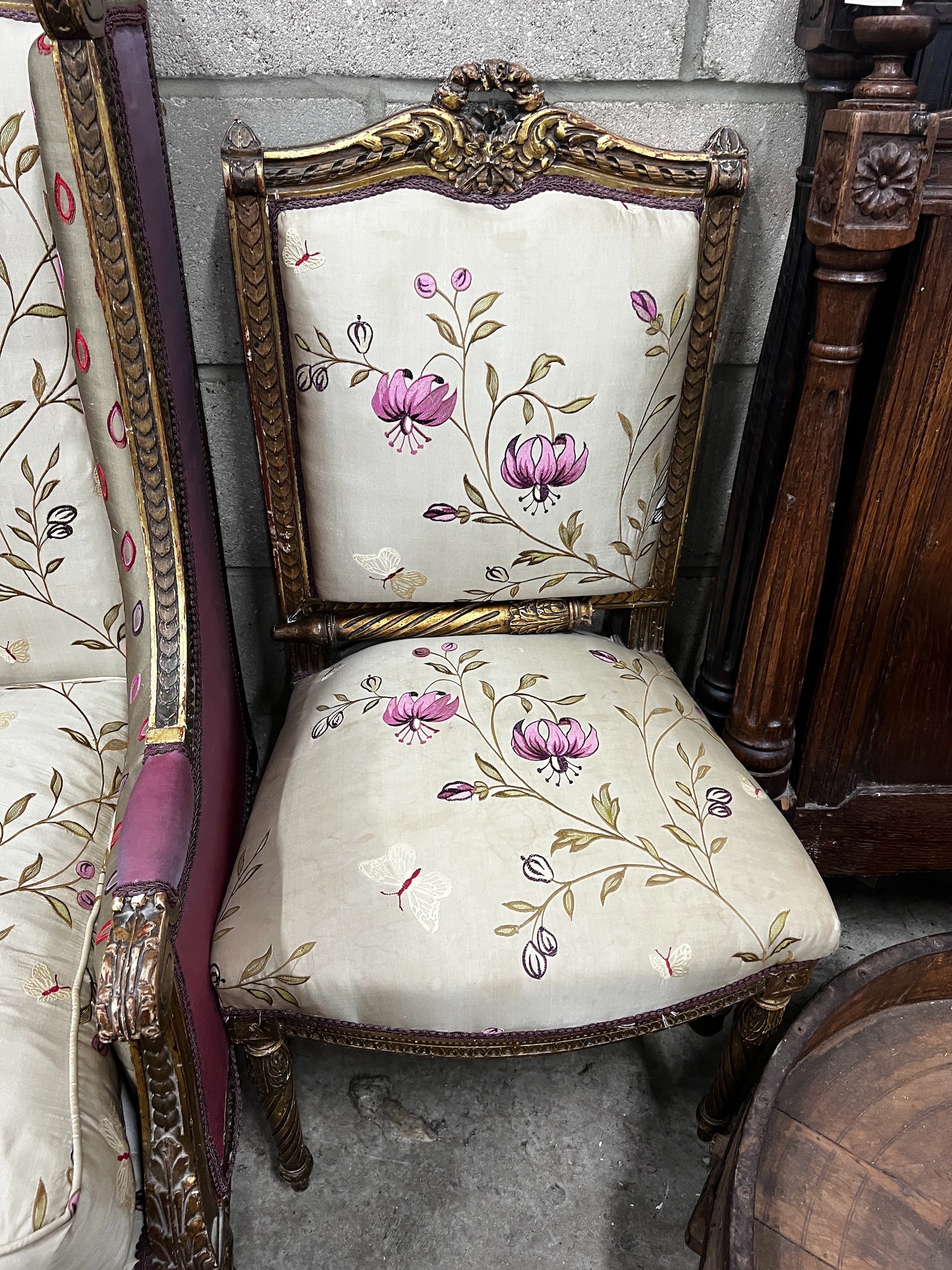 A late 19th century French carved giltwood and composition armchair, width 58cm depth 62cm height 104cm, with matching side chair